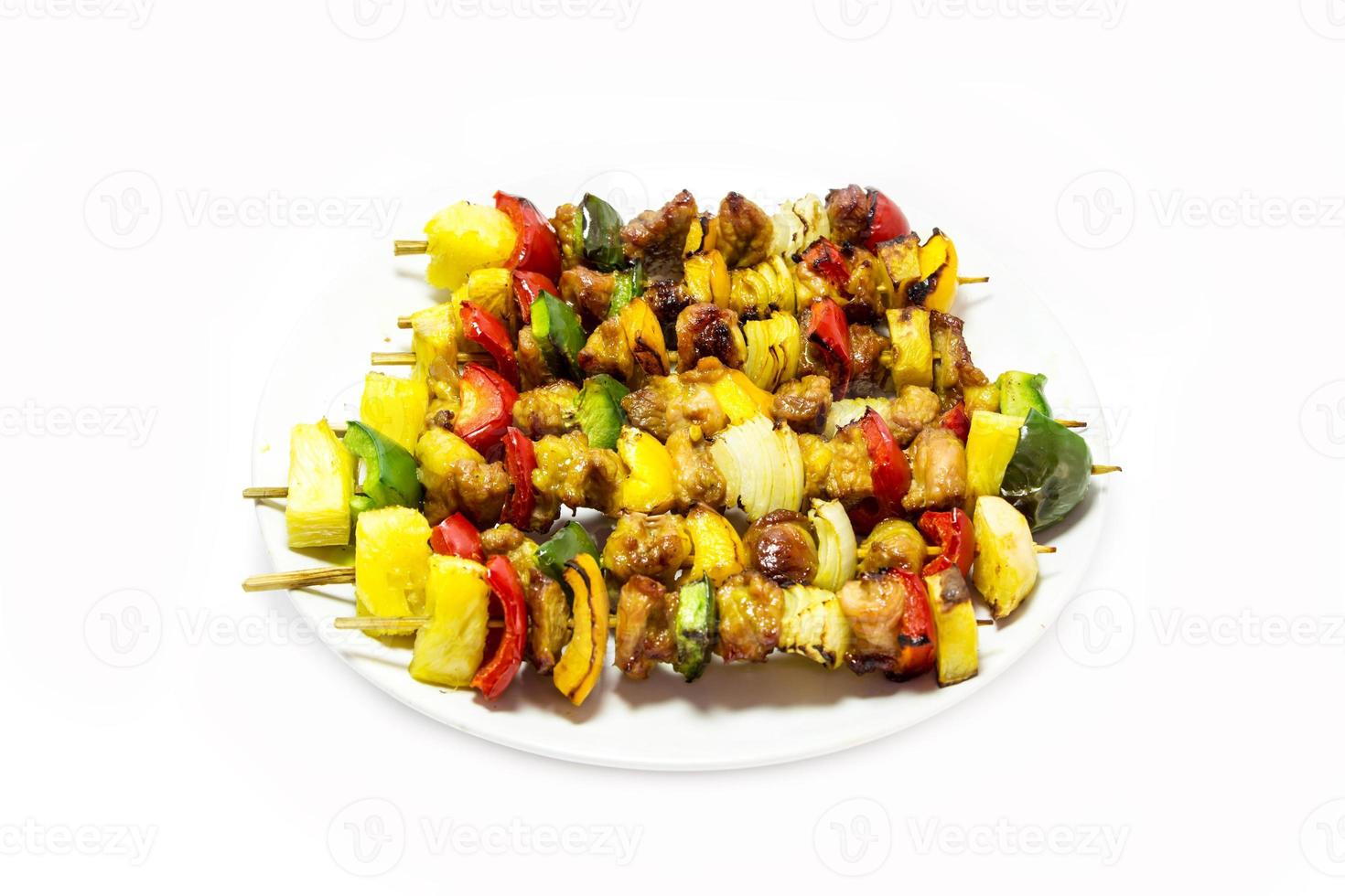 tasty grilled meat and vegetables on skewers, isolated on white photo