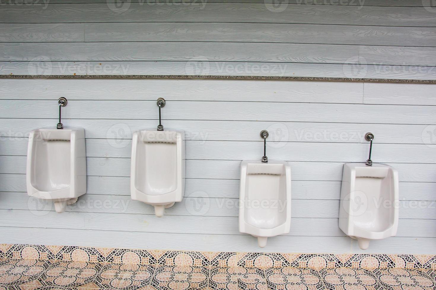 White urinals for men and boys in public toilet photo