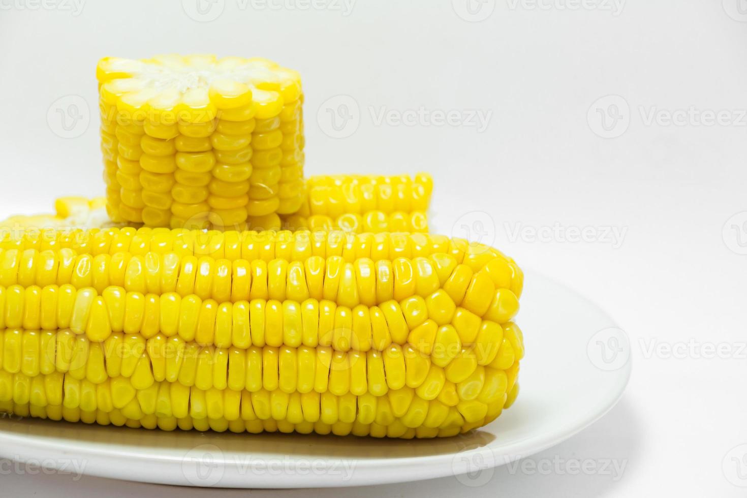 Boiled corn cobs isolated on white background photo