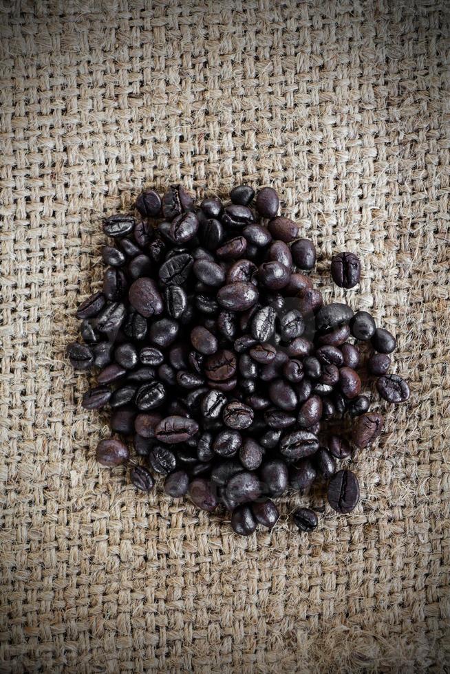 Coffee beans on burlap sack photo