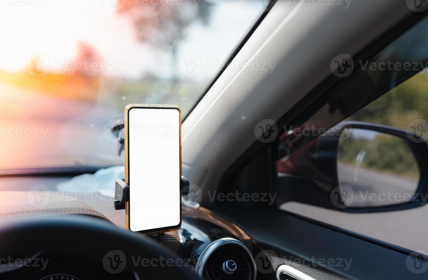 smartphone device gadget with white screen mounted on phone holder in car for gps navigator photo