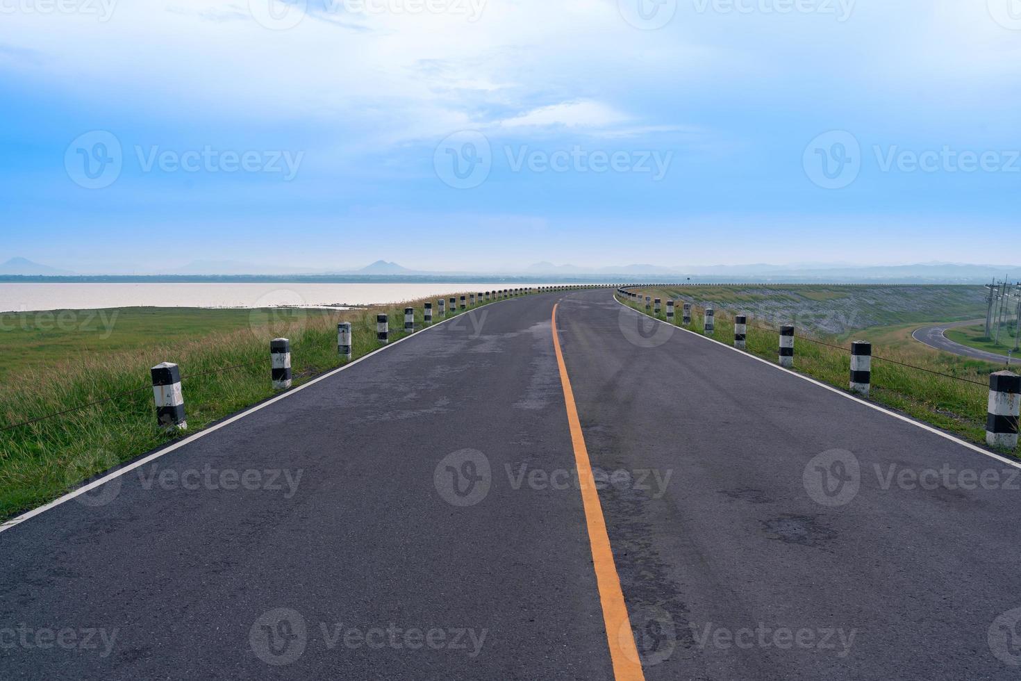 pavement asphalt road view leads to the horizon at Pasak Chonlasit Dam photo