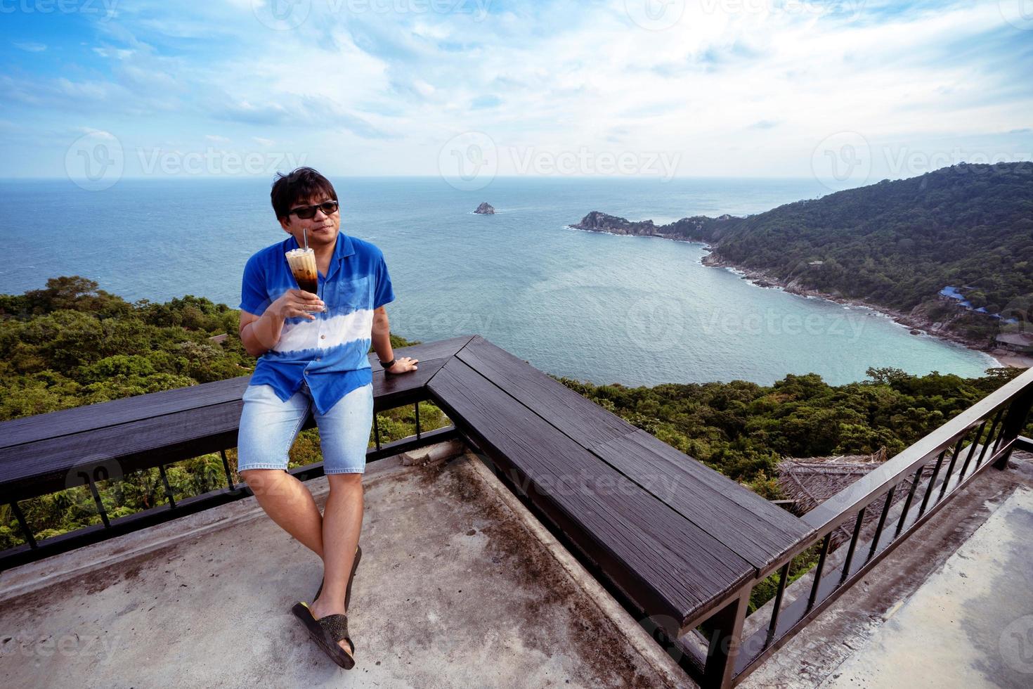 man relax with coffee and ocean view photo