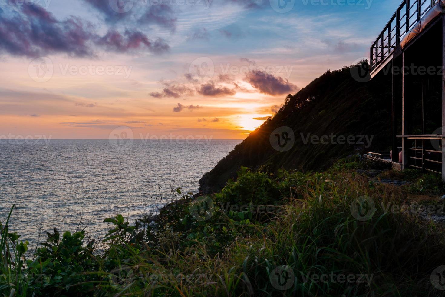 view above cliffs and sea from top hill in evening with beautiful sunset twilight sky photo