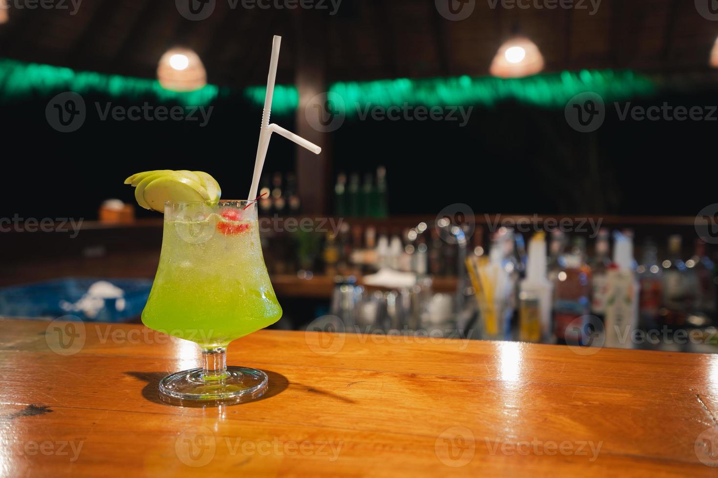midori sour cocktail on counter bar photo