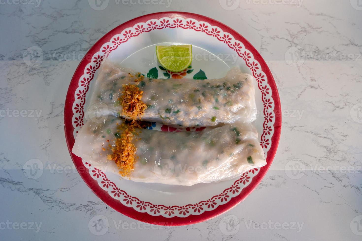 Vietnam style food steamed rice-skin dumplings with minced pork and vegetables topping with fried garlic on table photo