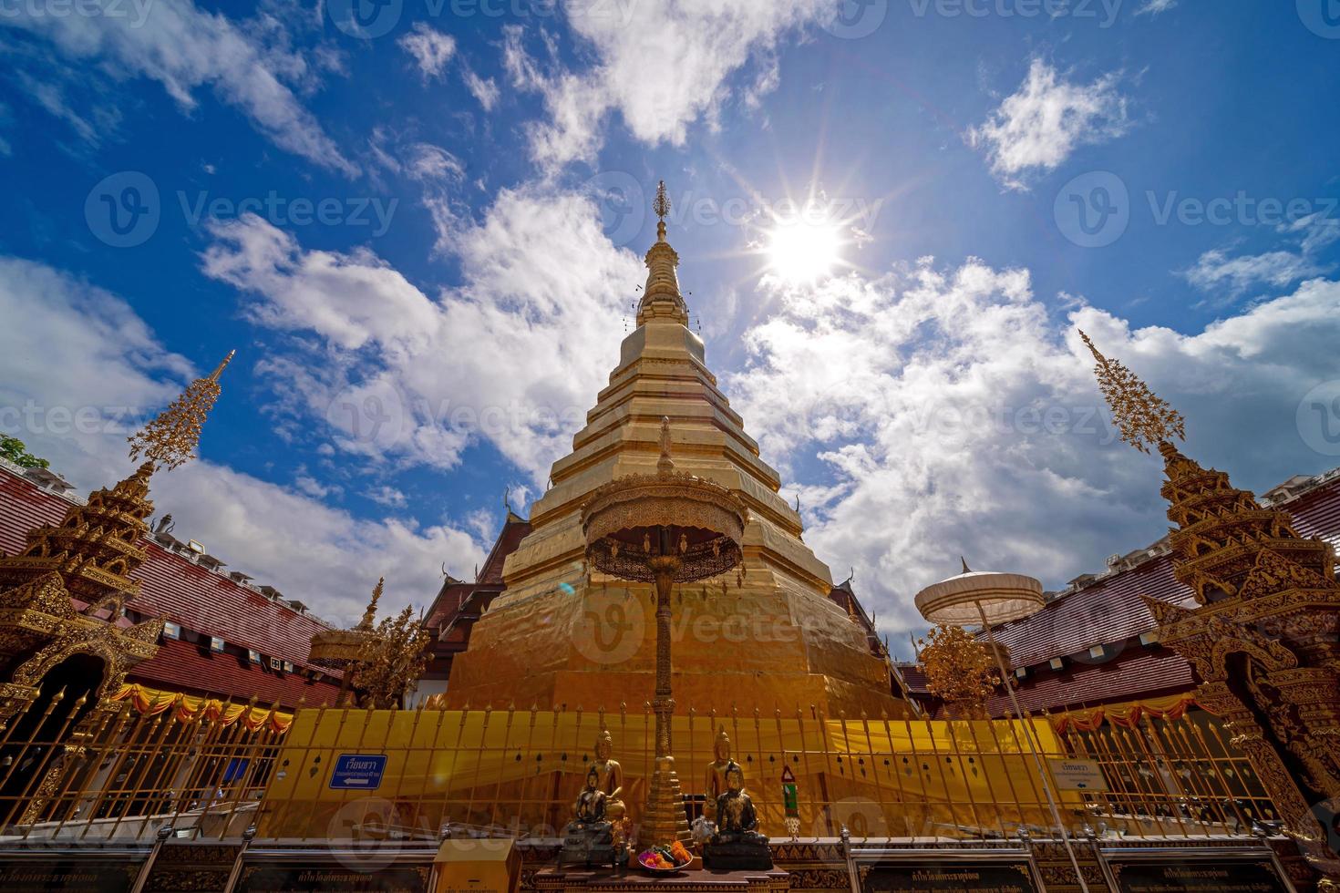 wide-angle view of golden pagoda at Wat Phra That Cho Hae Temple in Phrae photo