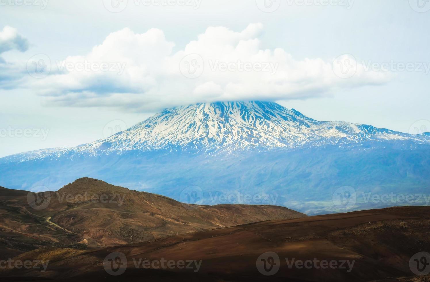 Landscape of snowy mountain ararat peak with cloud pass from Turkey side in spring. At the foot of mt Ararat photo