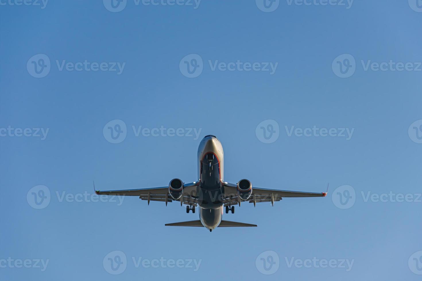 Passenger plane landing at the airport view from below photo