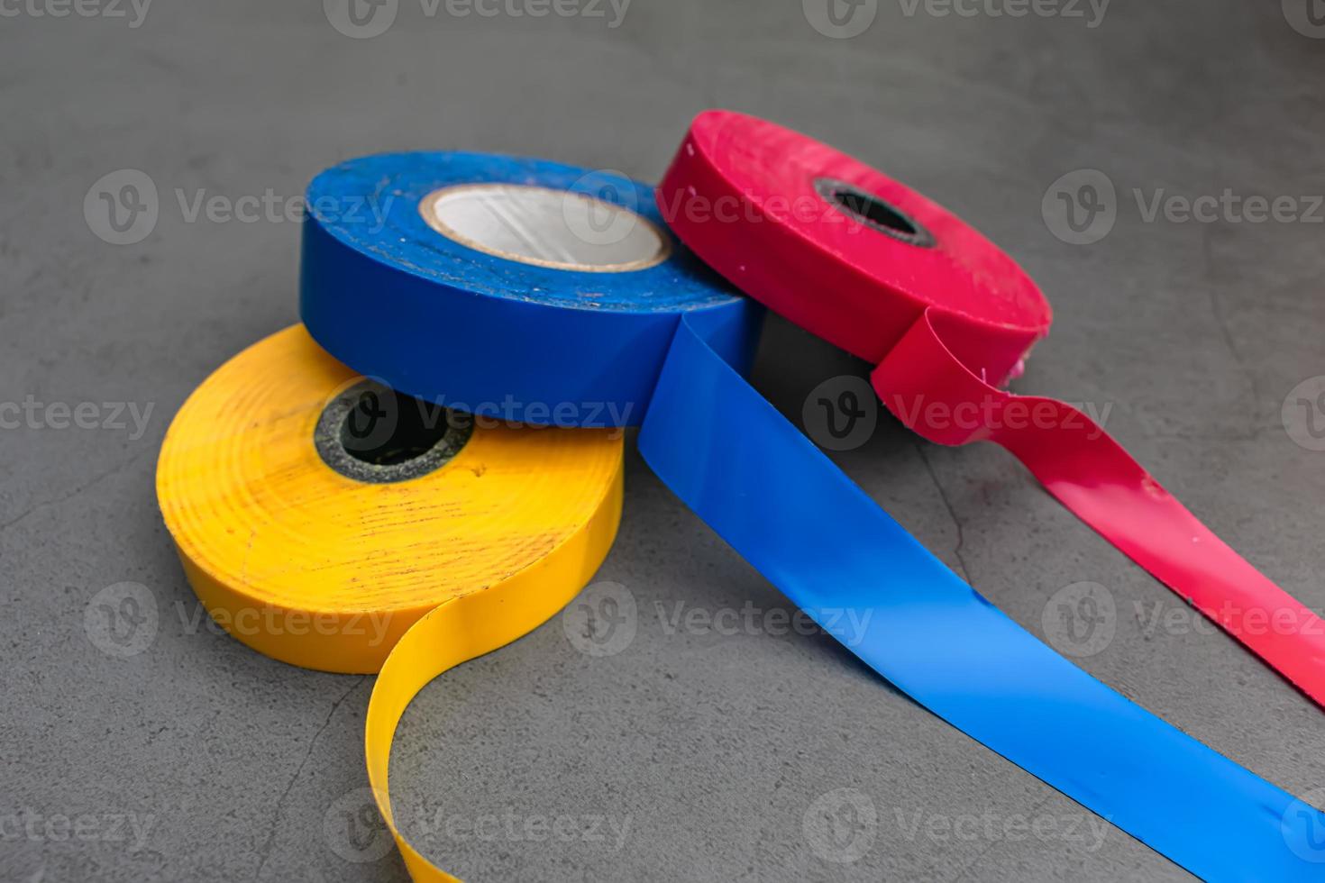 Three pieces of insulating adhesive tape in three colors photo