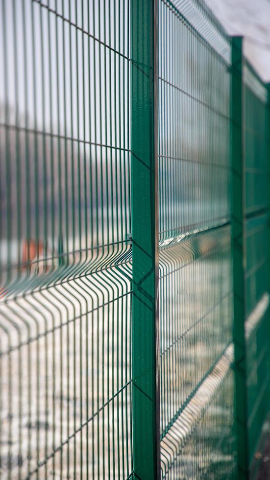 Green fence on construction site photo