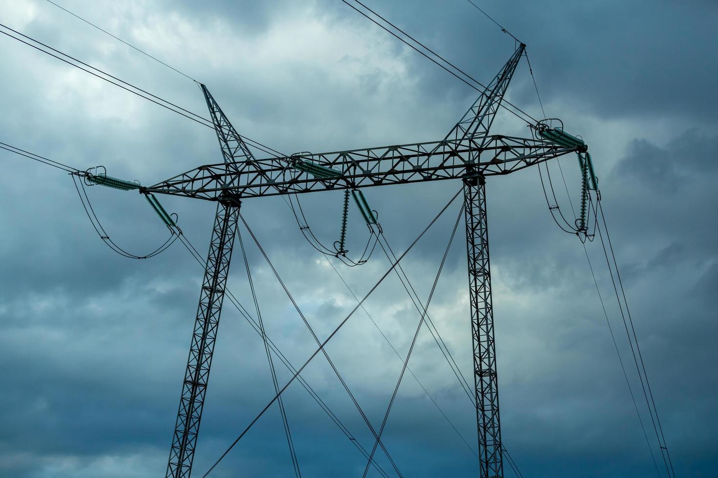 Powerlines on sky covered with clouds photo