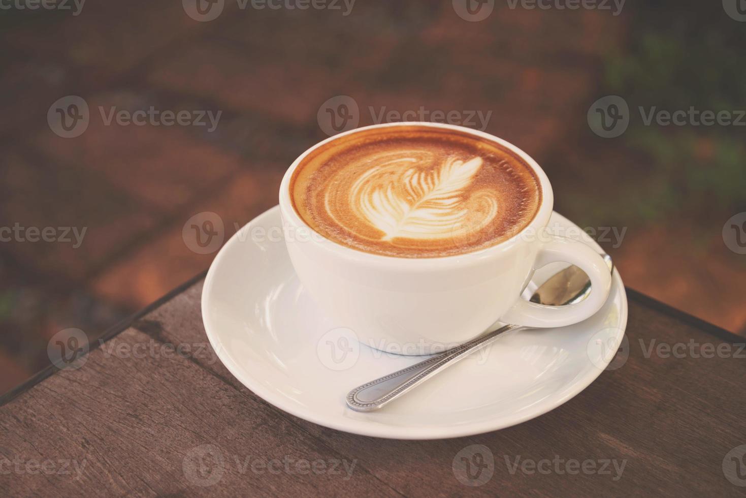 taza de café con leche en una cafetería con tono de color antiguo foto