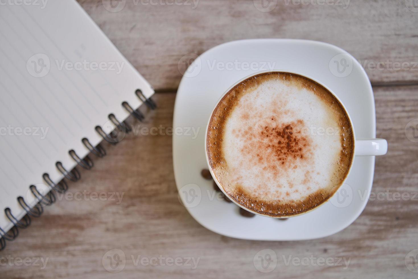 cappuccino coffee with note book photo