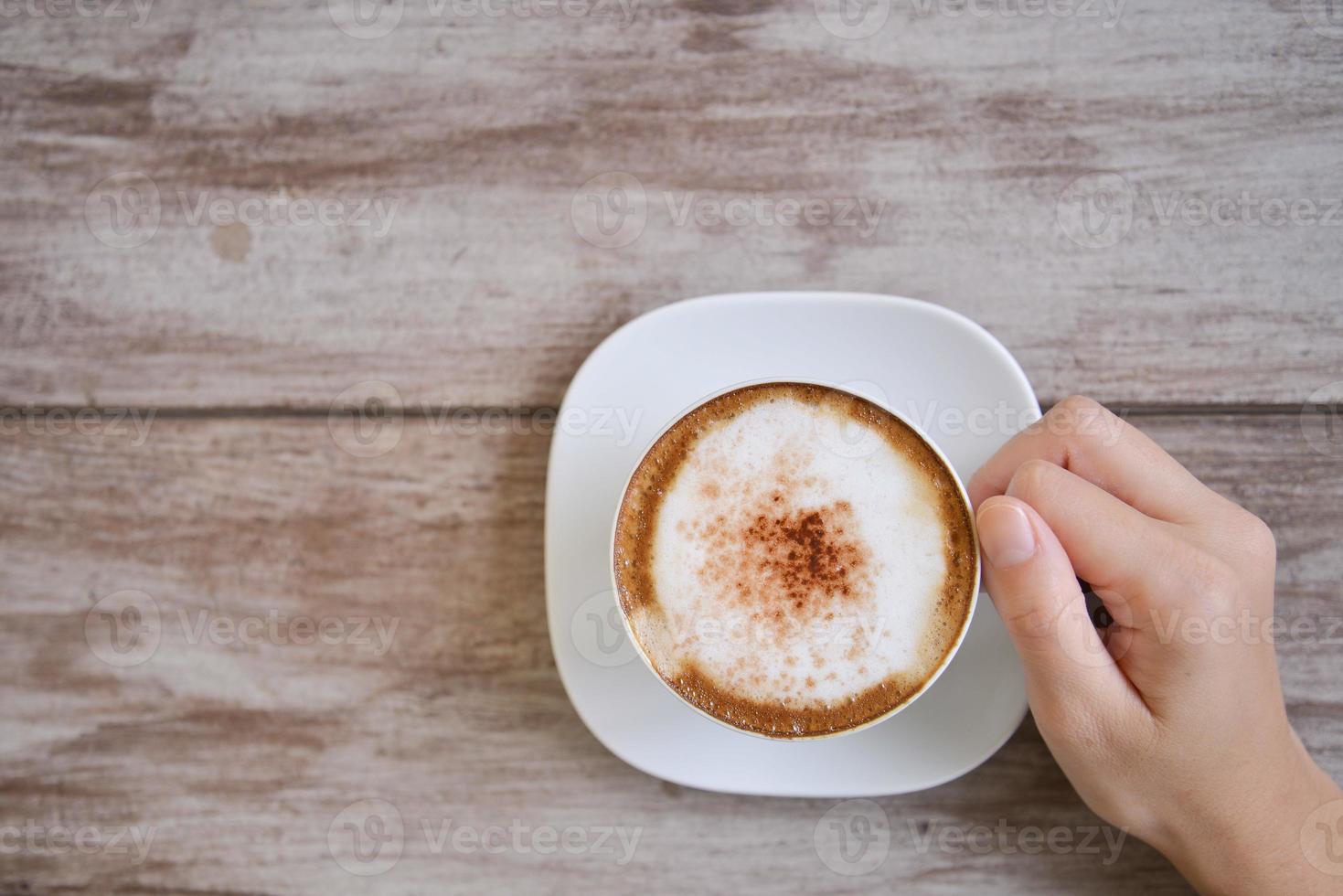 woman hands holding Latte art, coffee cup photo