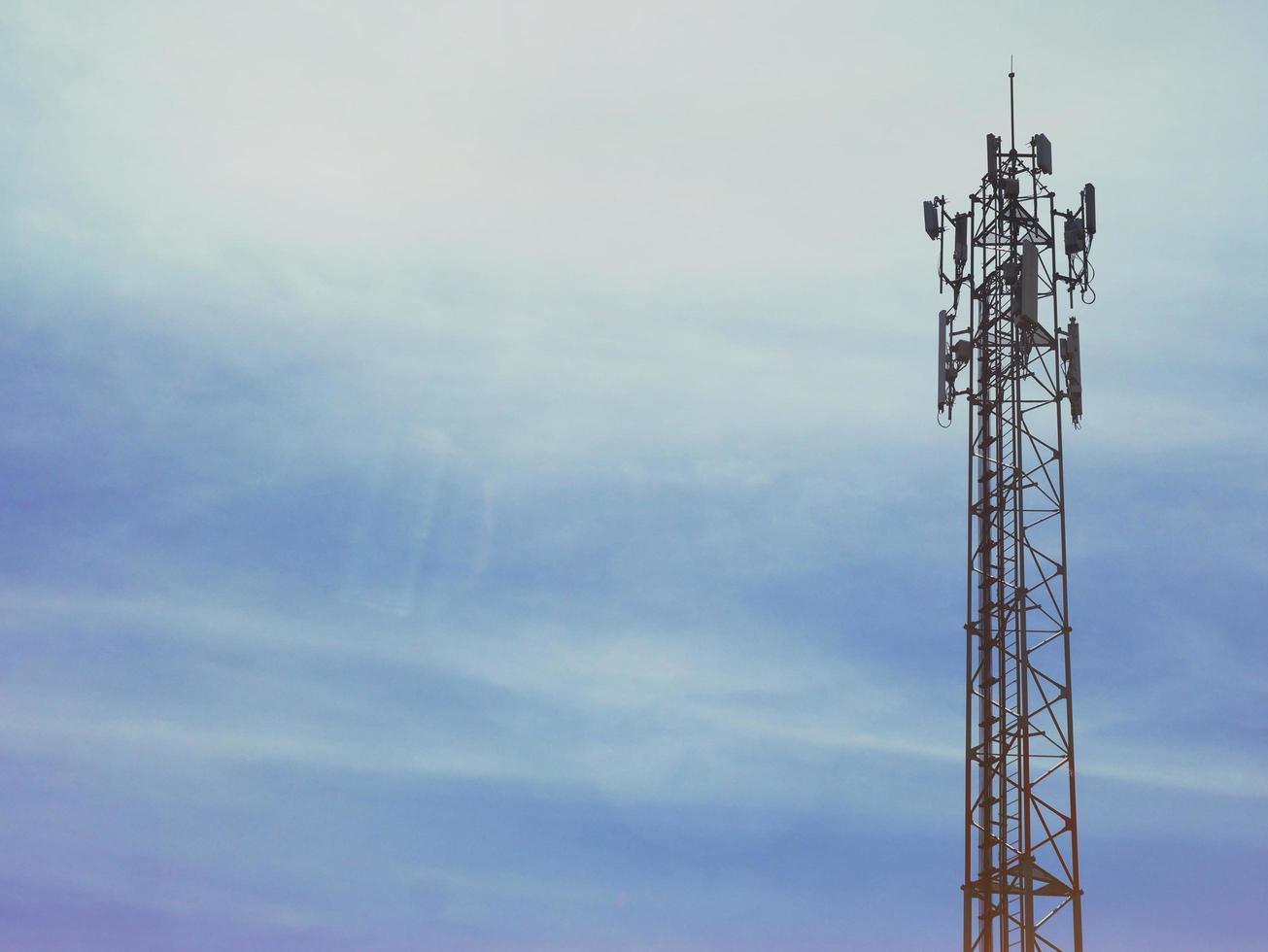 Telephone tower with white clouds in the background. photo