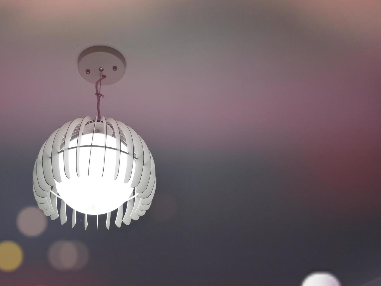 White lamps hanging on the ceiling. photo