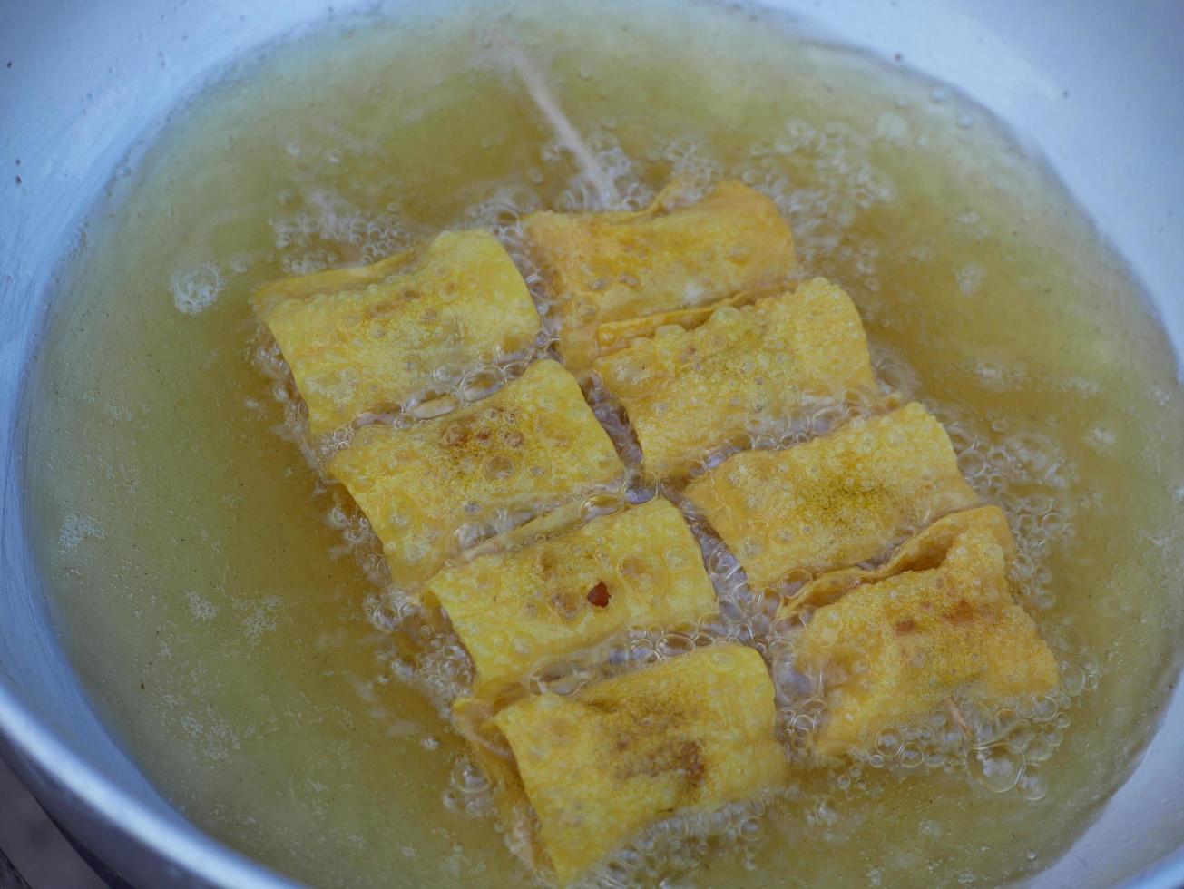 Fried dumplings in boiling oil photo