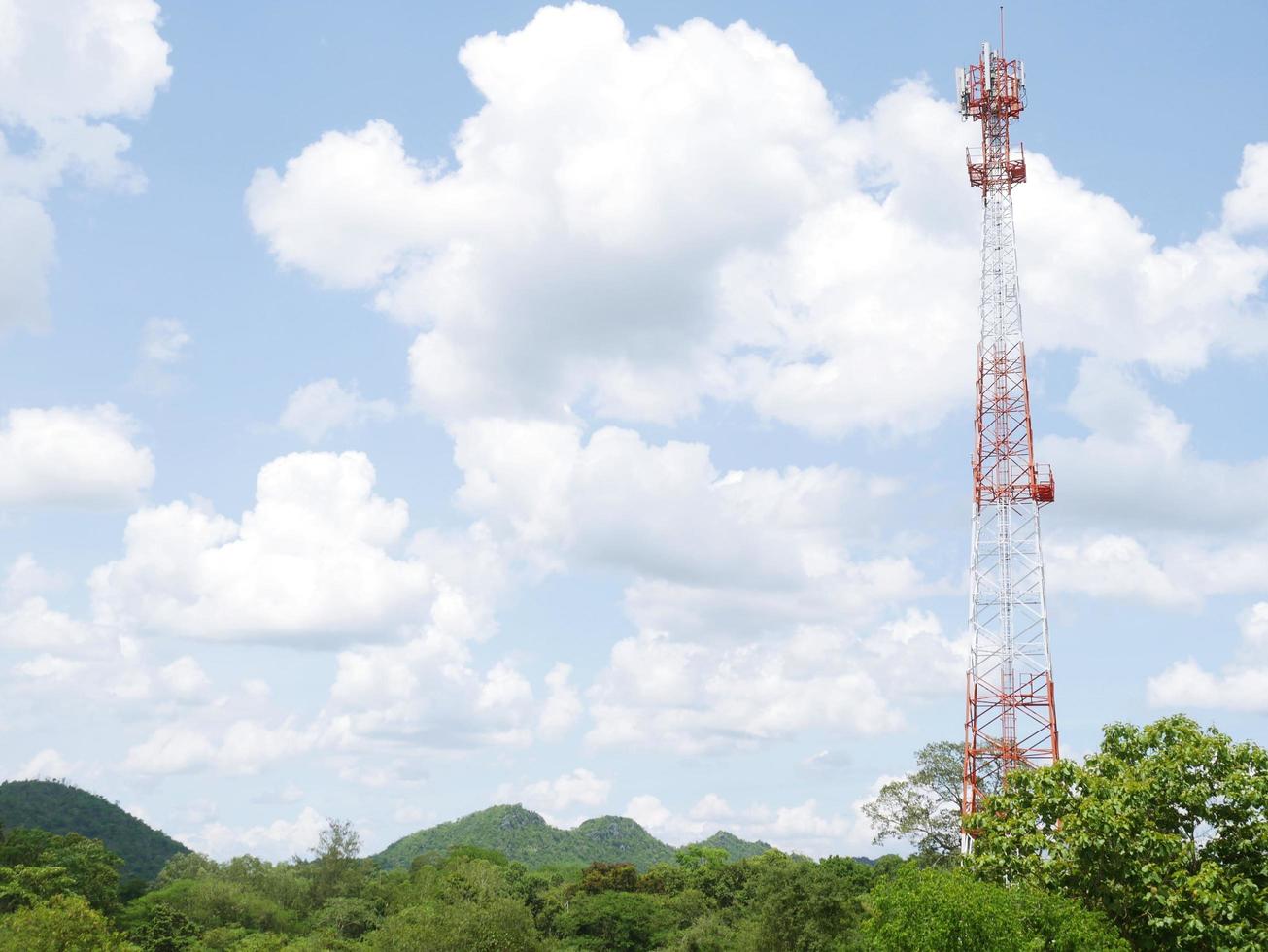 Telephone tower with white clouds in the background. photo