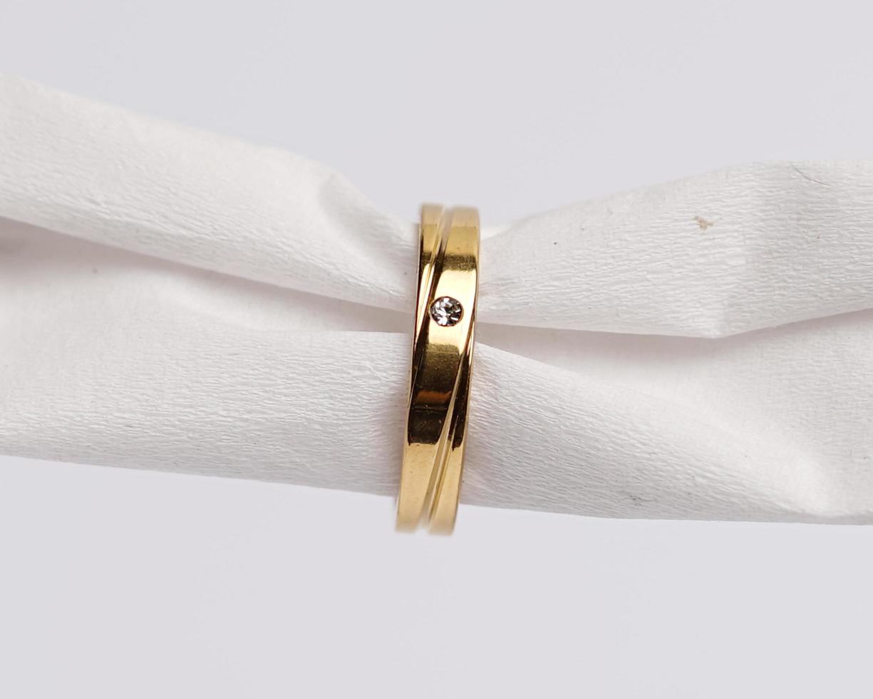 Concept photo of jewelry ring inserted in a roll of cloth. Wedding rings that have deep meaning and significance. Engagement ring with gemstones or diamonds. Wedding ring isolated on white background.