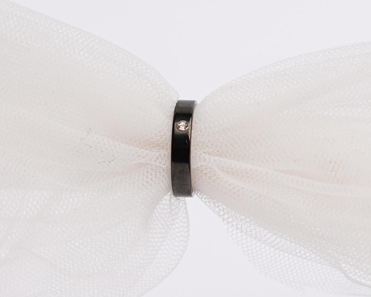 Concept photo of jewelry ring inserted in a roll of cloth. Wedding rings that have deep meaning and significance. Engagement ring with gemstones or diamonds. Wedding ring isolated on white background.