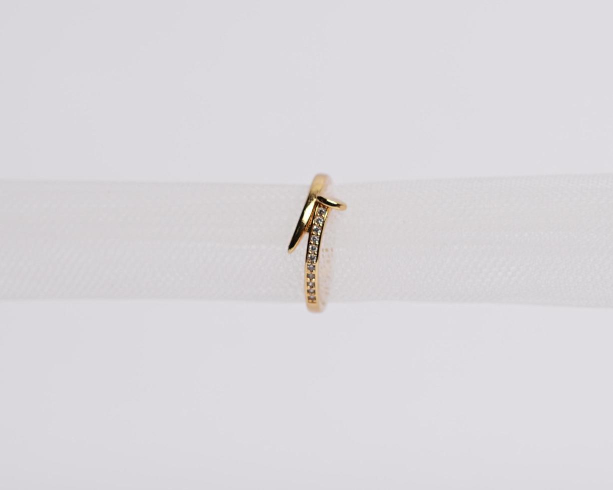 Concept photo of jewelry ring inserted in a roll of cloth. Wedding rings that have deep meaning and significance. Engagement ring with gemstones or diamonds. Wedding ring isolated on white background.