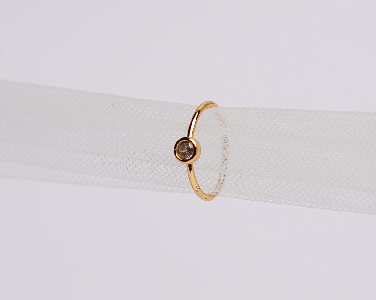 Concept photo of jewelry ring inserted in a roll of cloth. Wedding rings that have deep meaning and significance. Engagement ring with gemstones or diamonds. Wedding ring isolated on white background.
