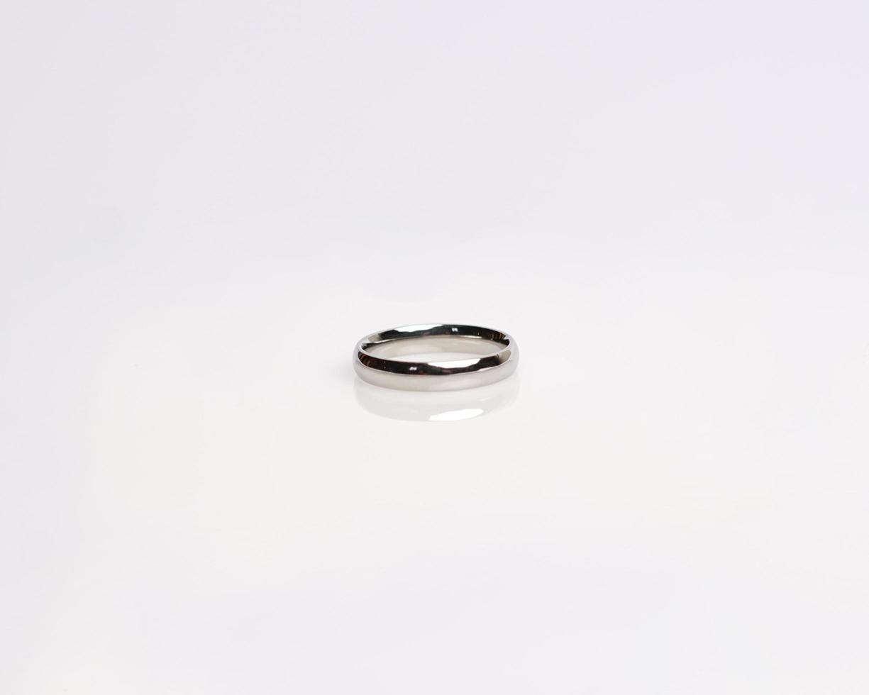 Jewelery ring with diamonds. Wedding rings that have deep meaning and significance. Engagement ring with gemstones. Wedding ring isolated on white background, focus blur. Pair in gold, silver, black. photo