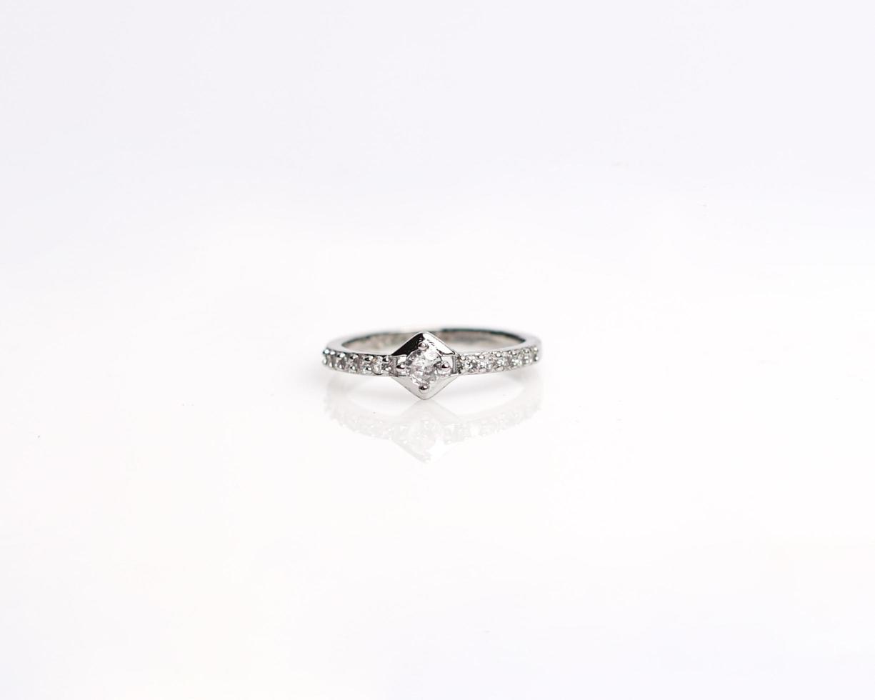 Jewelery ring with diamonds. Wedding rings that have deep meaning and significance. Engagement ring with gemstones. Wedding ring isolated on white background, focus blur. Pair in gold, silver, black. photo