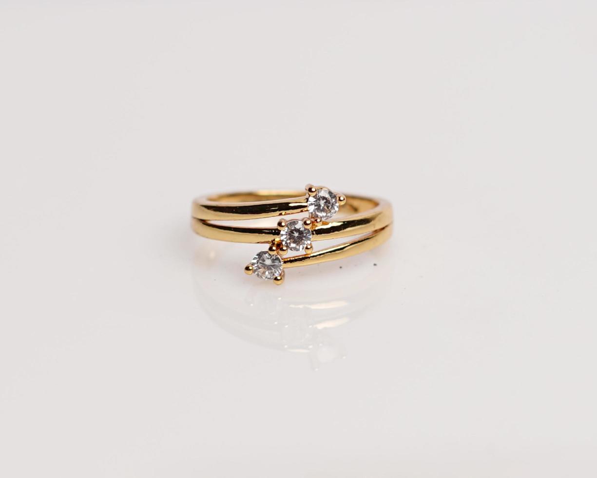 Jewelery ring with diamonds. Wedding rings that have deep meaning and significance. Engagement ring with gemstones. Wedding ring isolated on white background, focus blur. Pair in gold, silver, black. photo