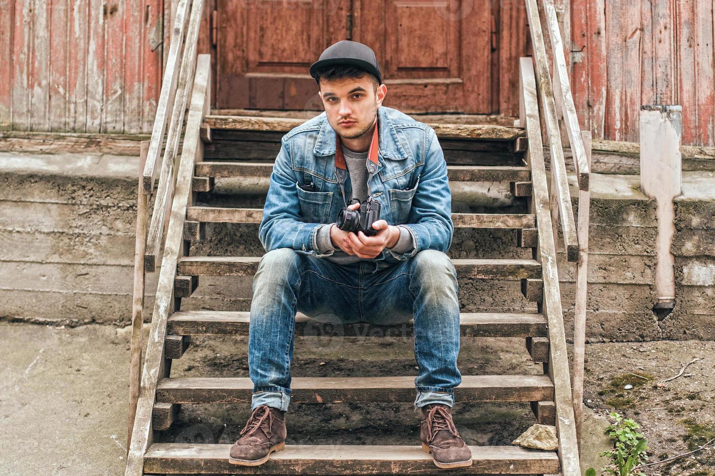 Man sitting on a wooden staircase. Old house photo