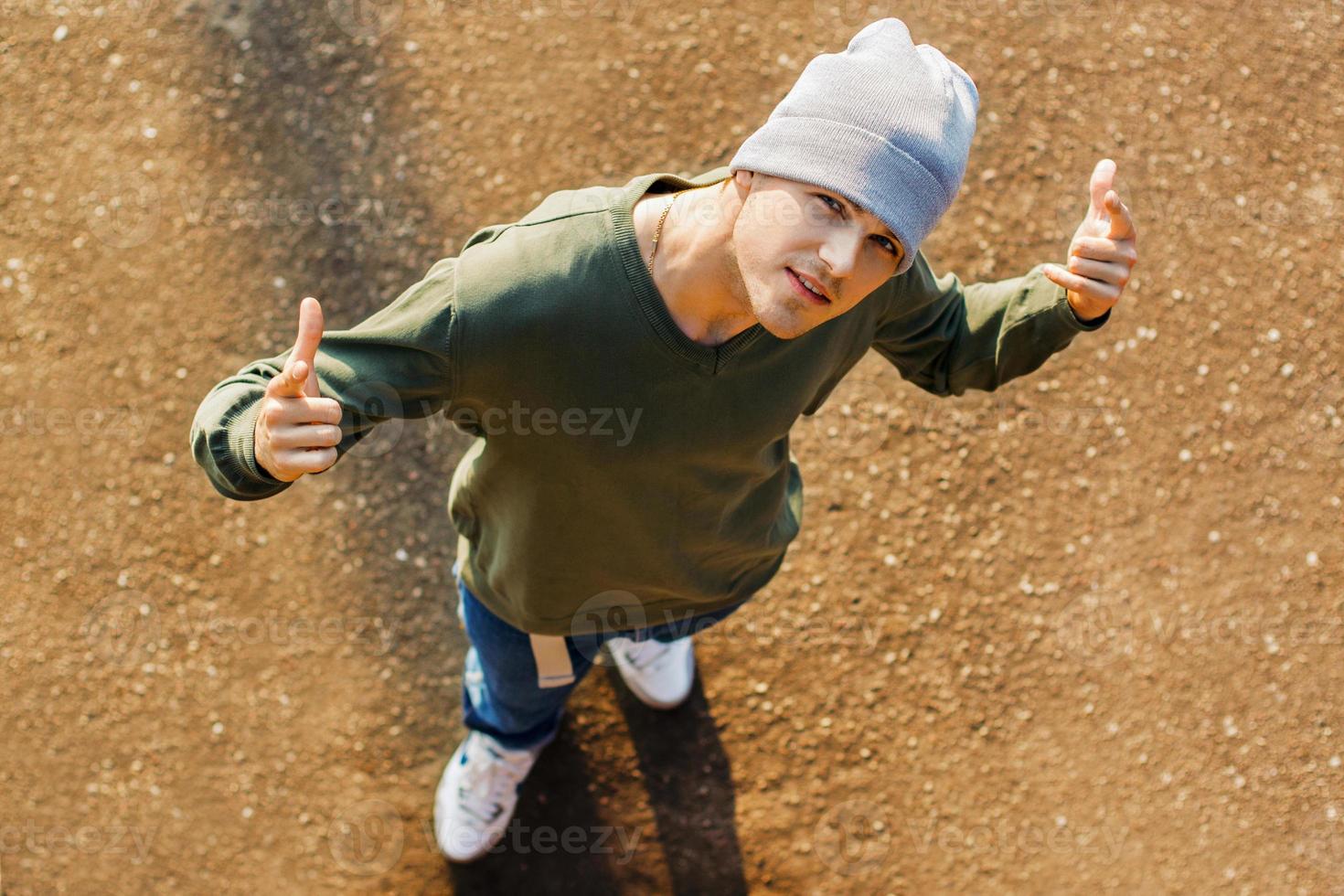 Fashionable handsome dancer guy dancing in the street photo