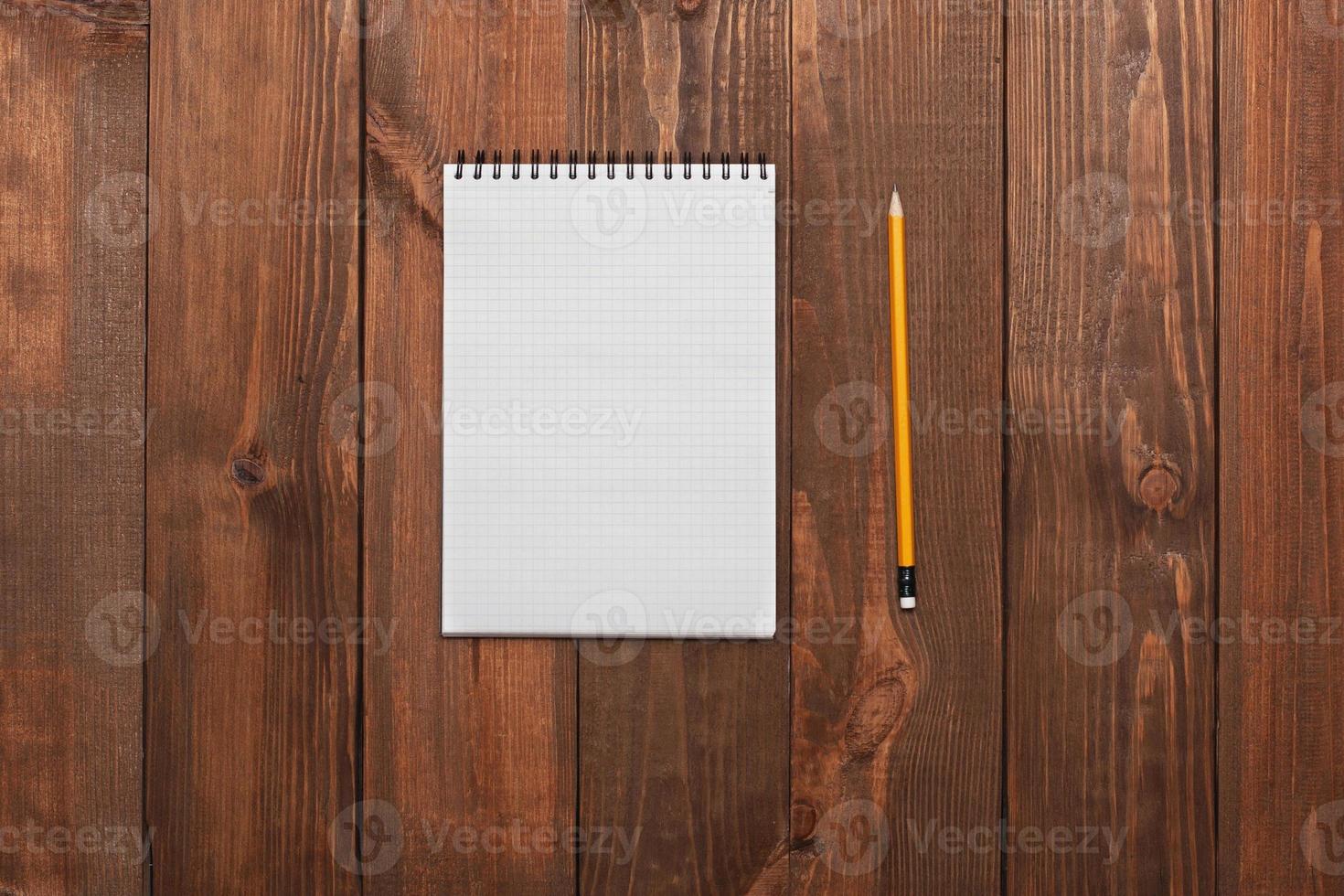 Notebook with a pencil on the table photo