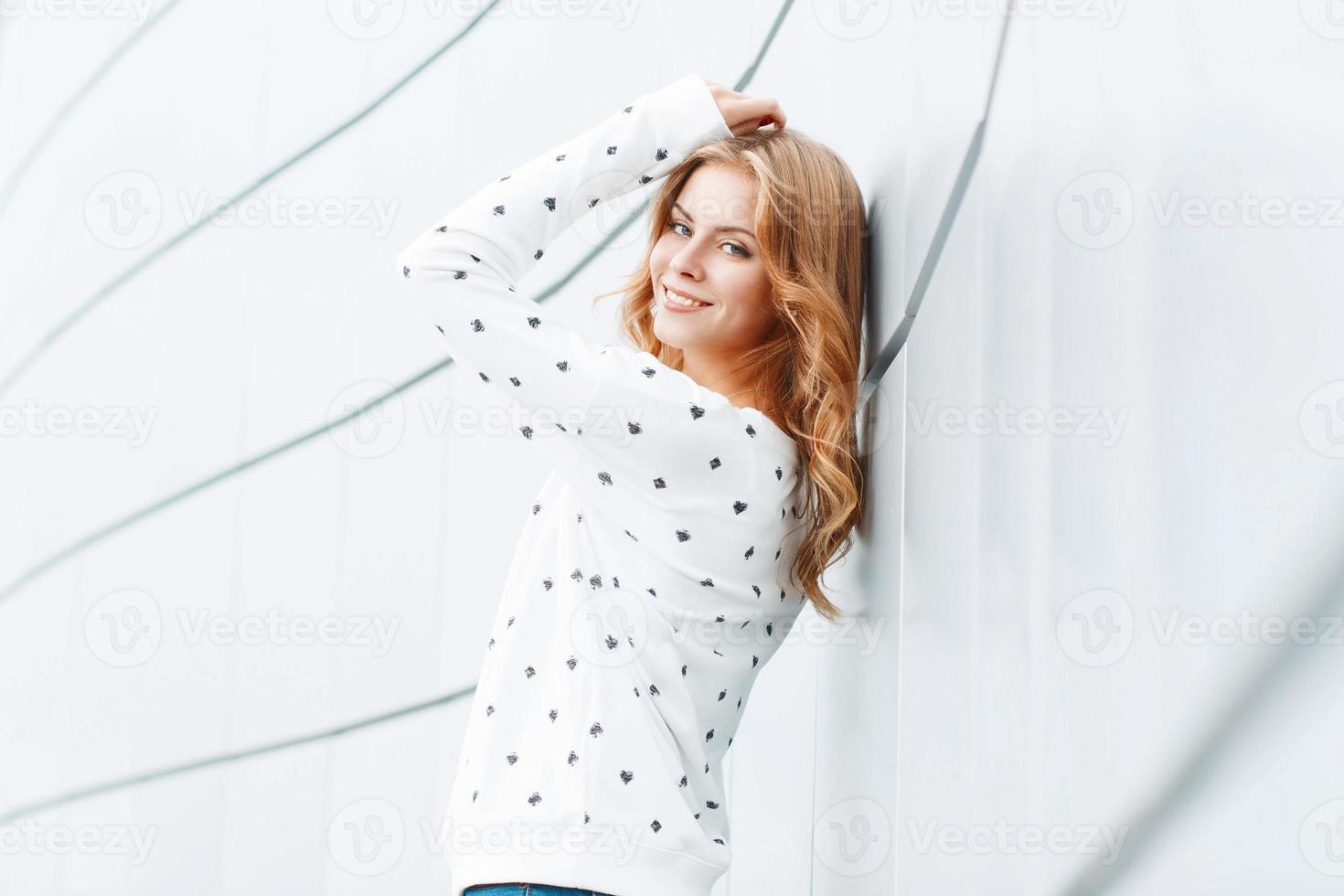 Beauty portrait pretty woman in the city summer near white metal wall photo