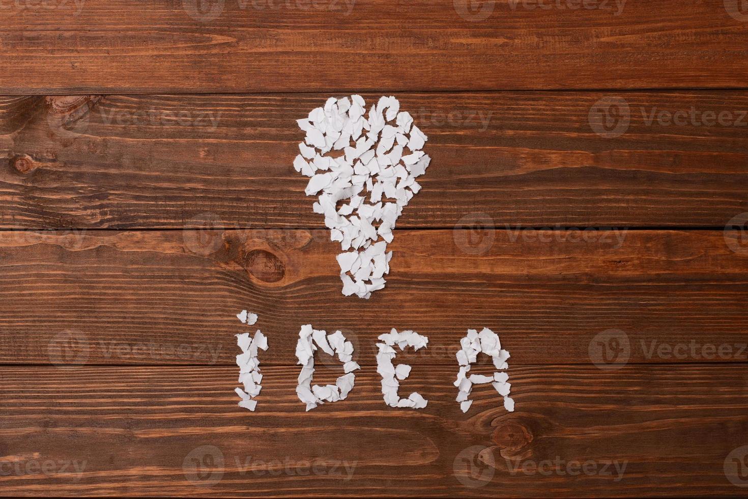 Idea. Pieces of paper on the table in the shape of lamp. photo