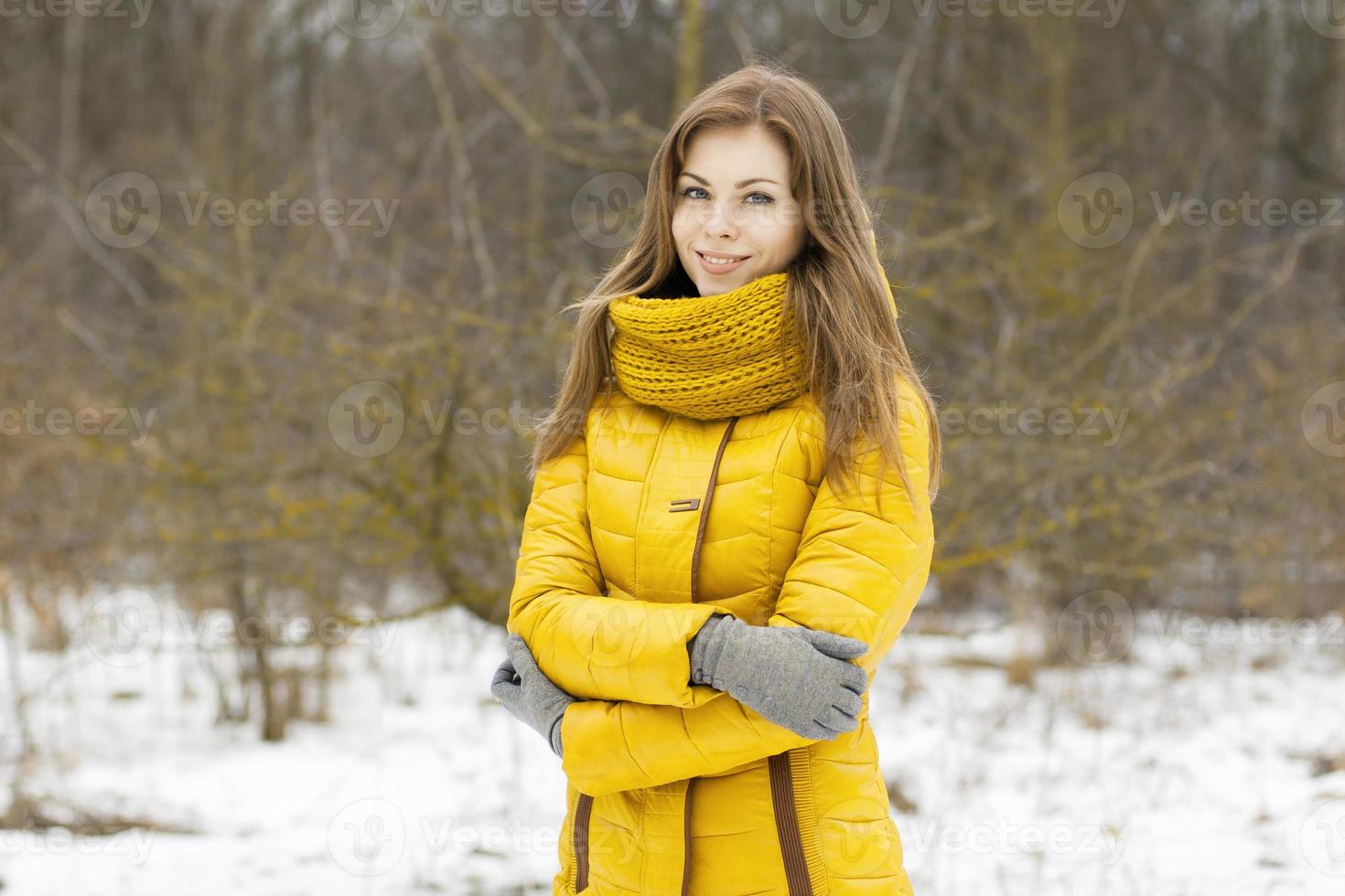 Pretty woman in a yellow knit scarf. Outdoor portrait in the park. photo