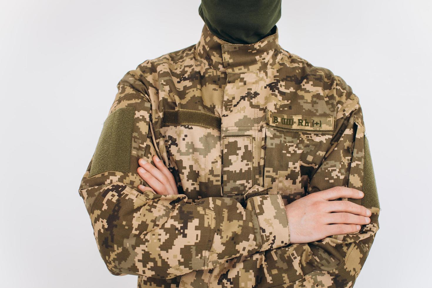 Portrait of a Ukrainian soldier in military uniform on a white background photo