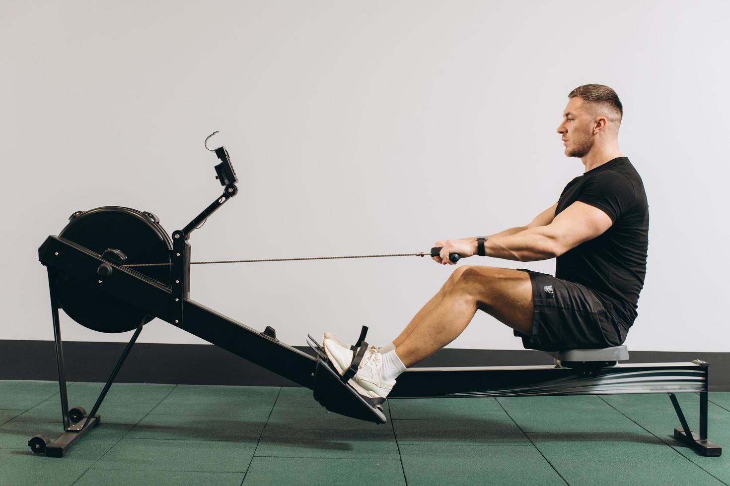 Man running rowing excercise in the gym photo