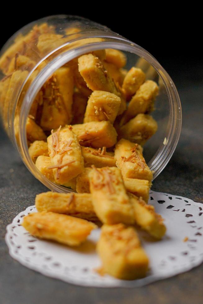 Crunchy kaastengels cookies. Dutch influenced Indonesian cookies, typically served during hari raya Eid Fitri. Selective focus image on black background photo