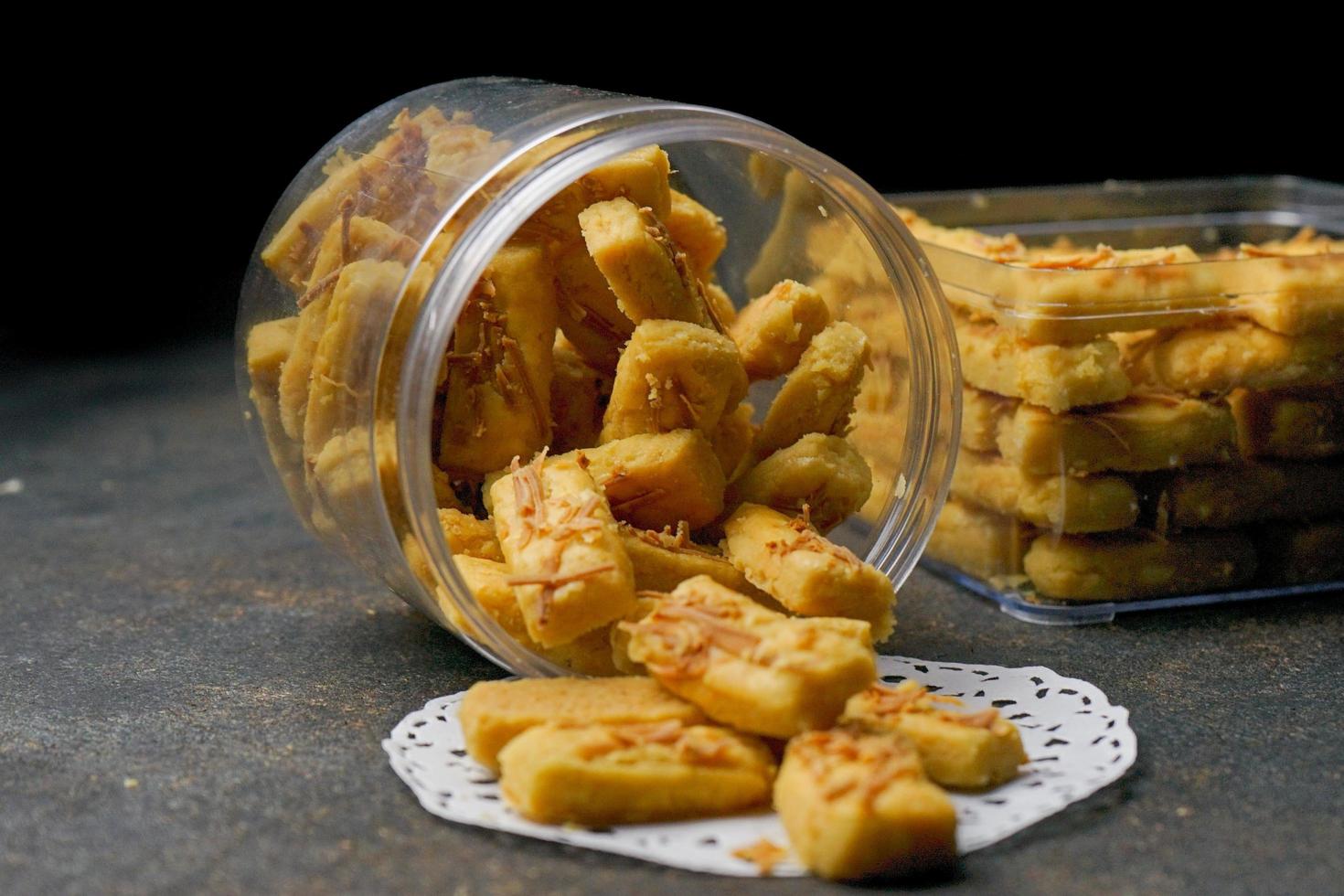 Crunchy kaastengels cookies. Dutch influenced Indonesian cookies, typically served during hari raya Eid Fitri. Selective focus image on black background photo