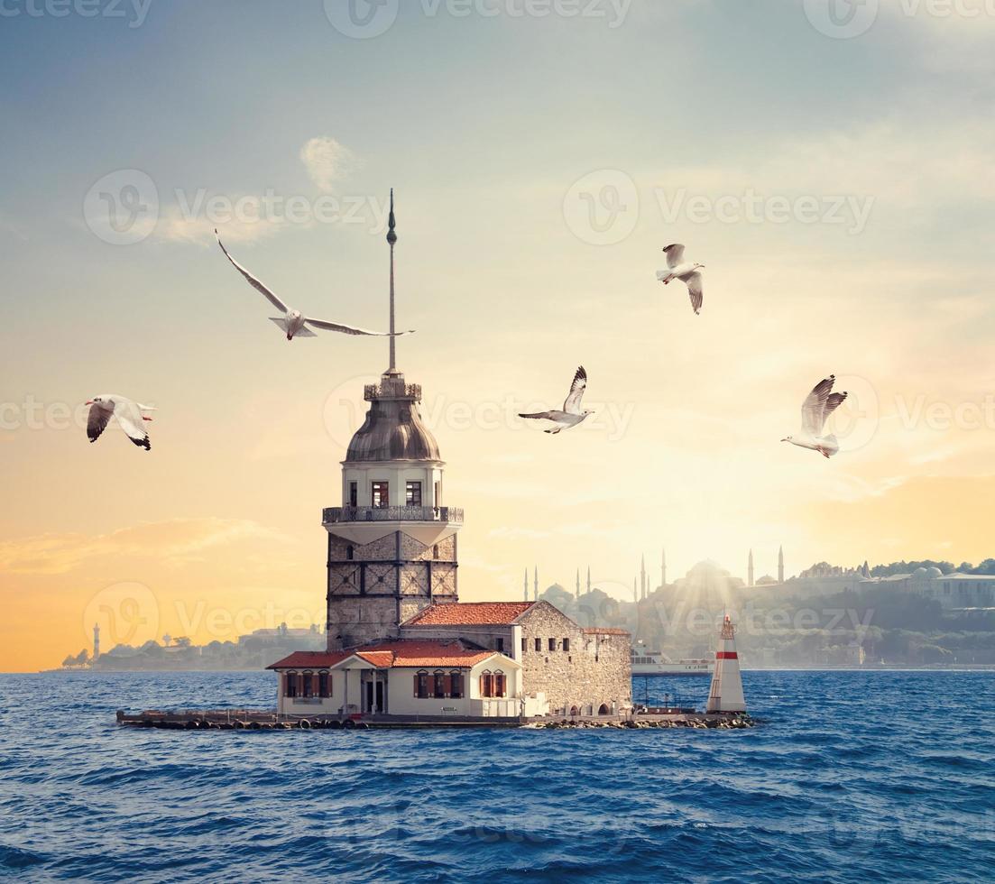Maiden's Tower and Istanbul silhouette at sunset photo