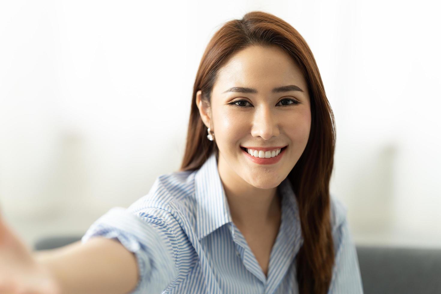 Young asian woman taking selfie. webcam and video conference concept. photo