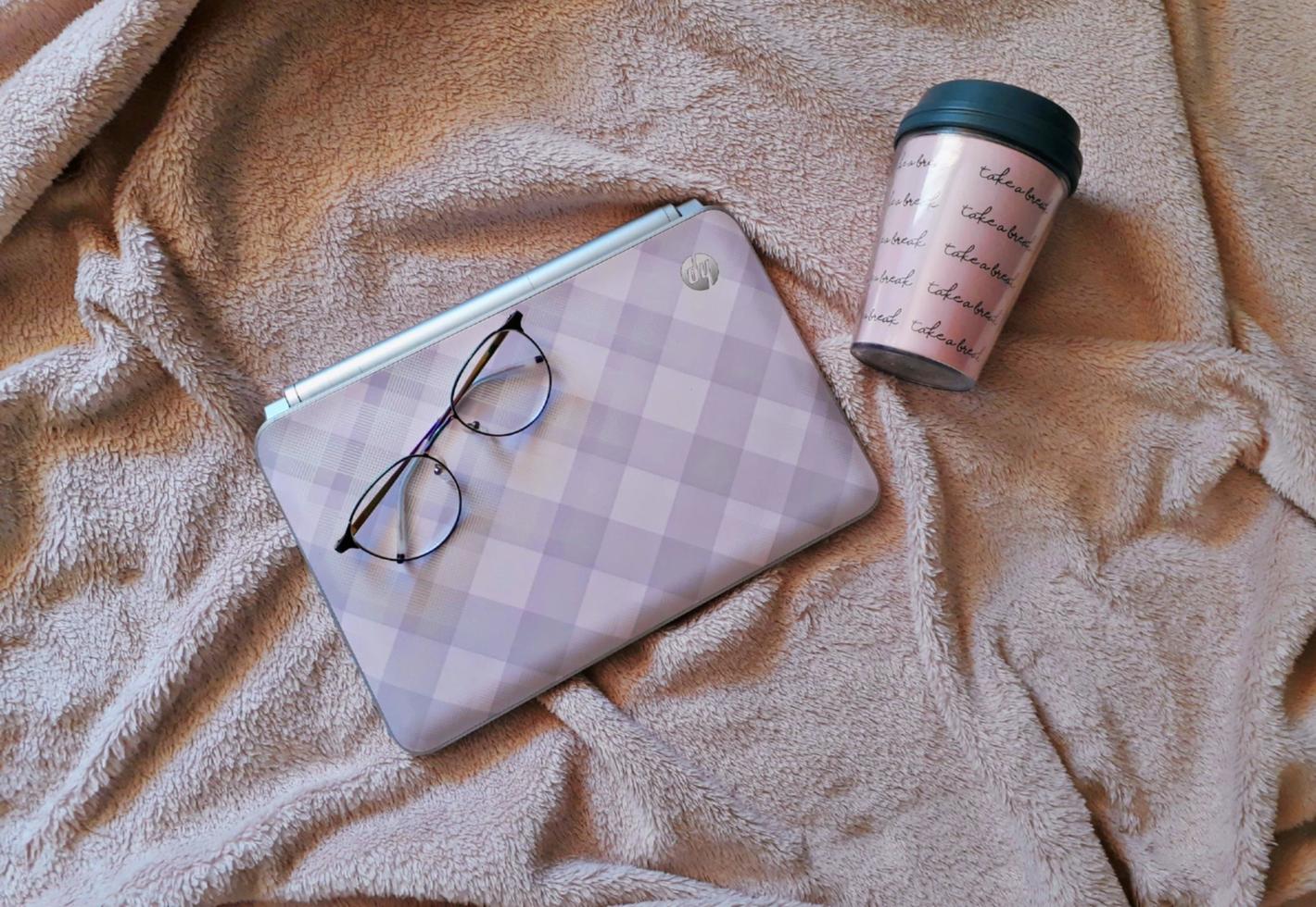 Laptop and glasses on the towel photo