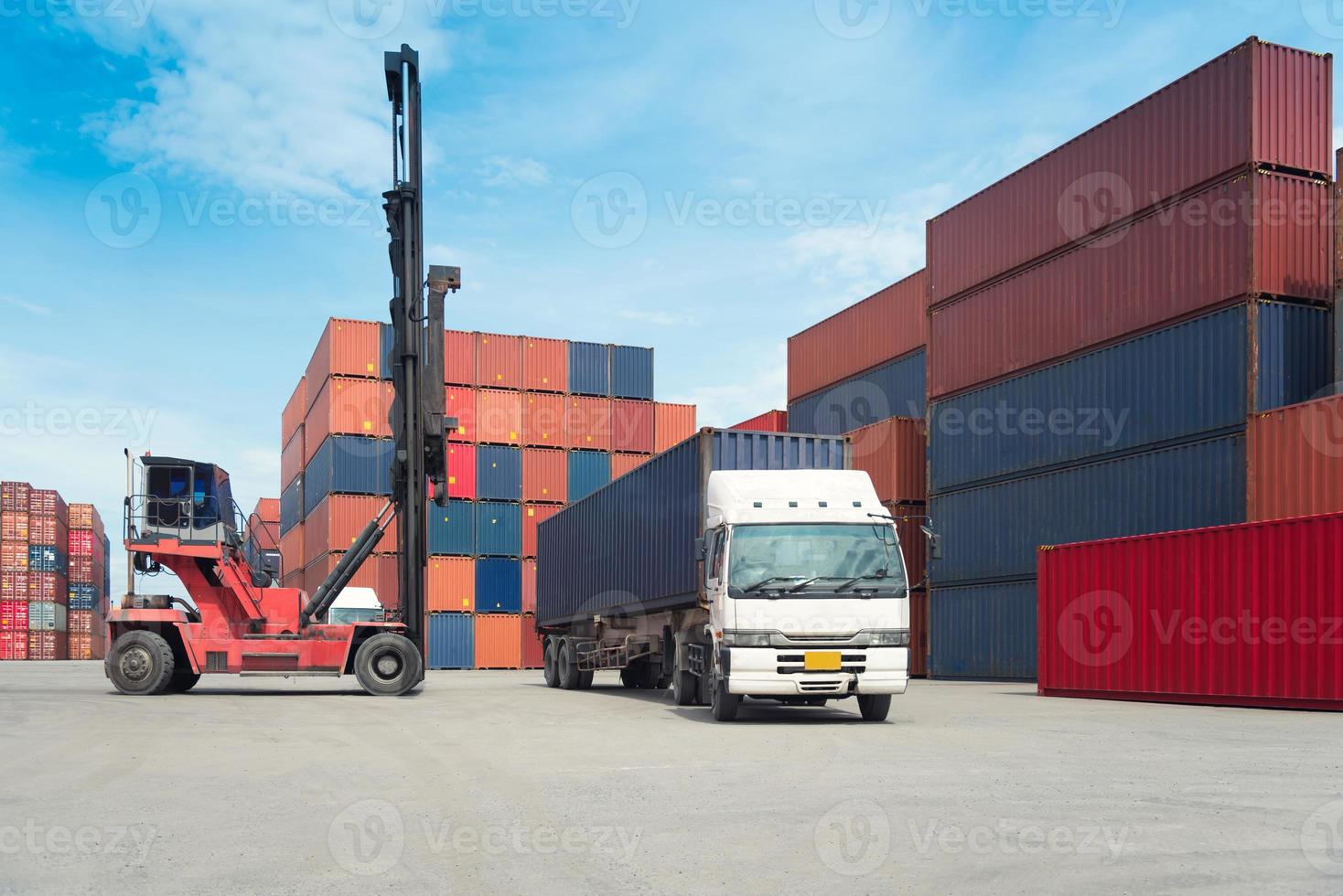 Forklift handling container box loading to freight train in import and export photo