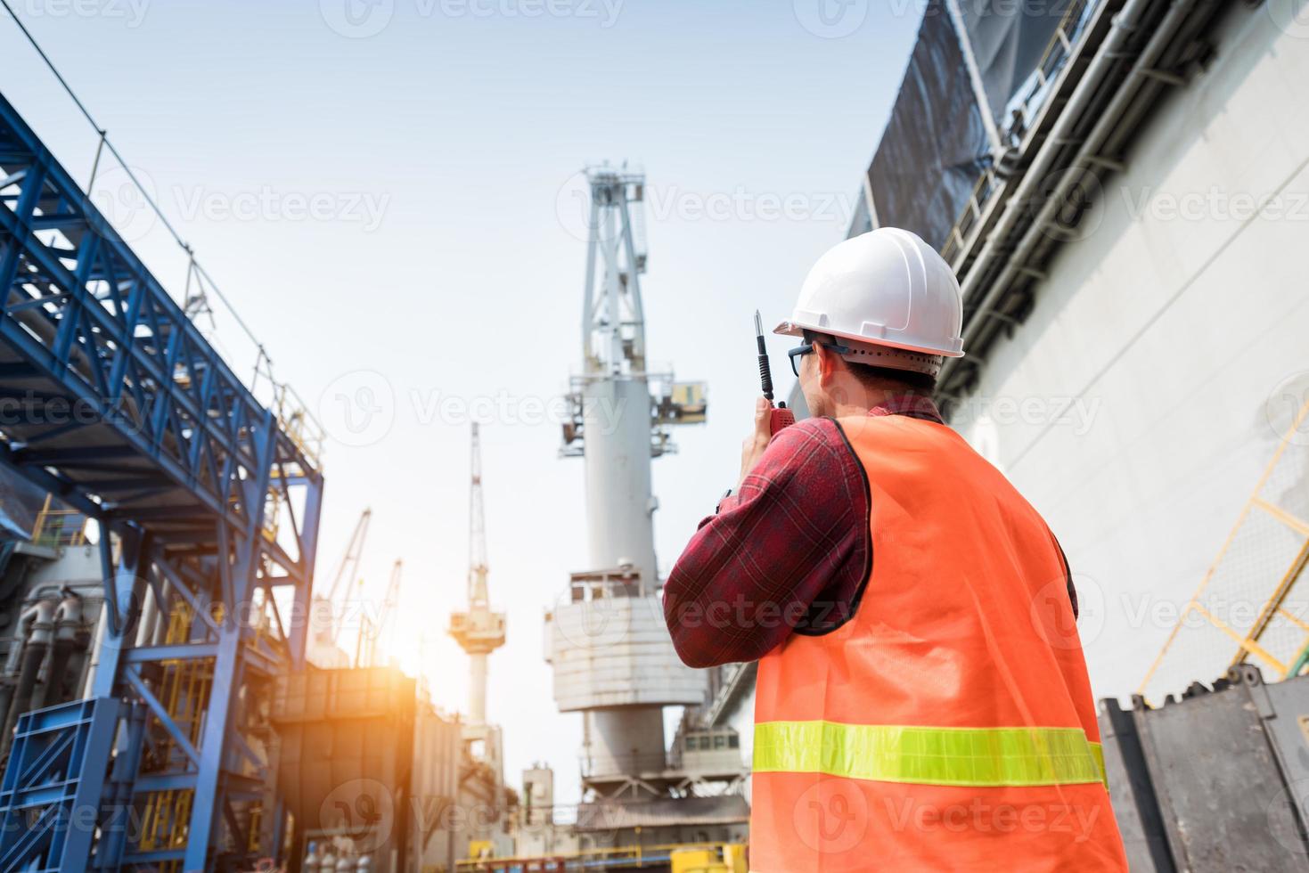 Foreman control loading Containers box from Cargo freight ship photo