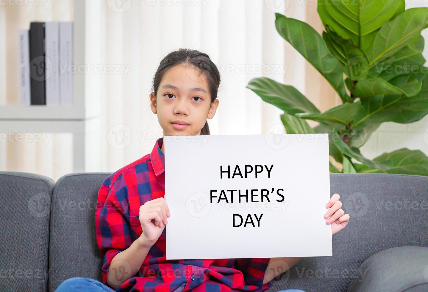 Asian girl with white sheet of paper, girl holding paper with Happy father's day message, mock up blank sign for message creative design concepts photo