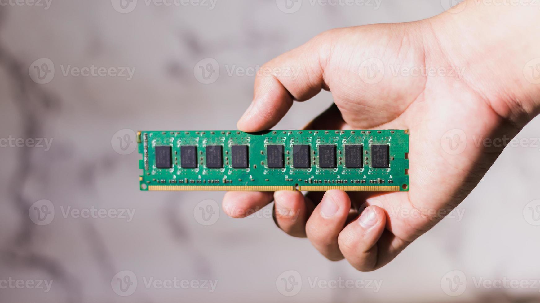 Close up male hand holding a ddr3 computer ram on abstack white background photo