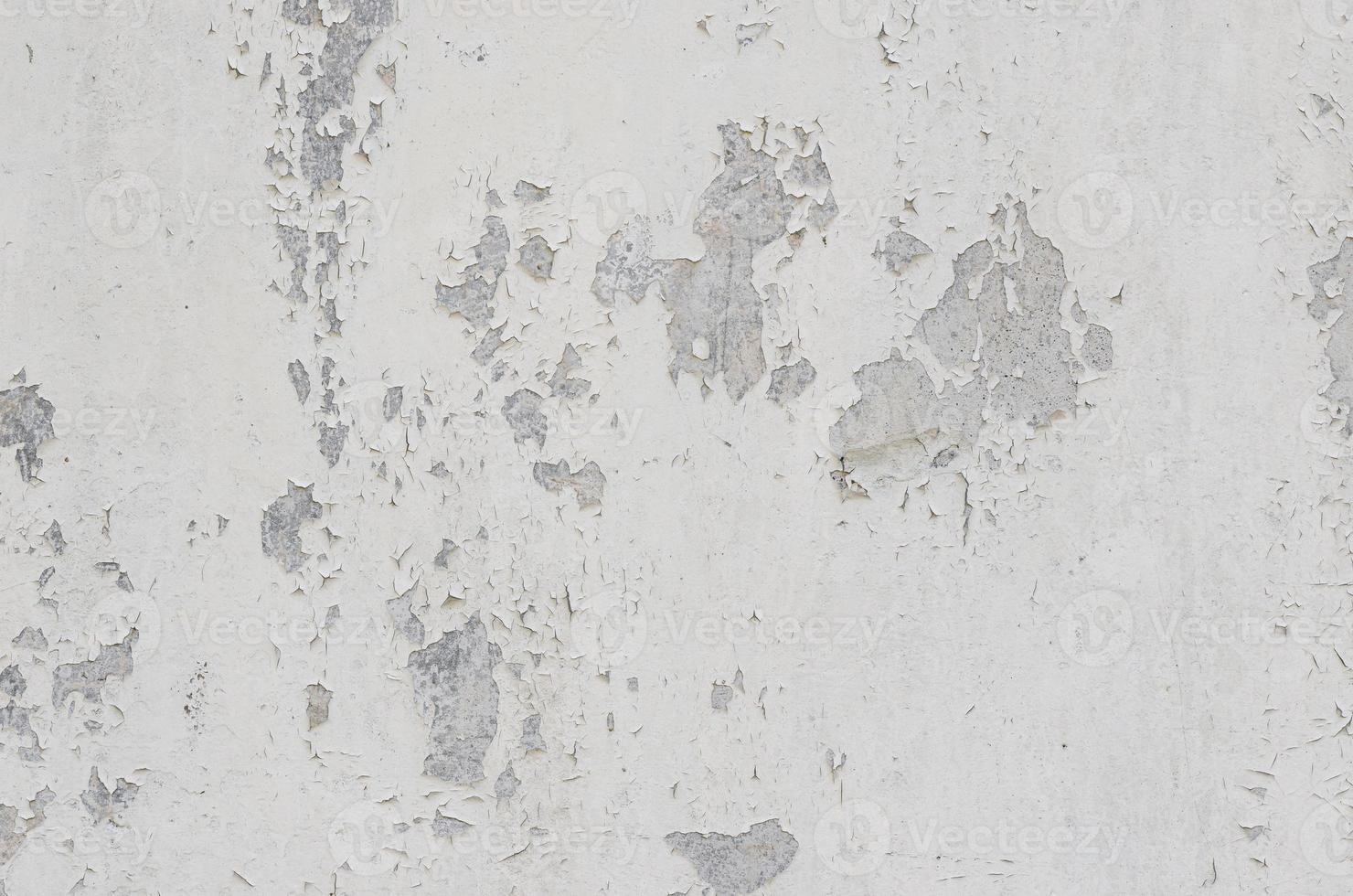 white white background and texture of peeling paint on plaster wall because  old paint expired. photo