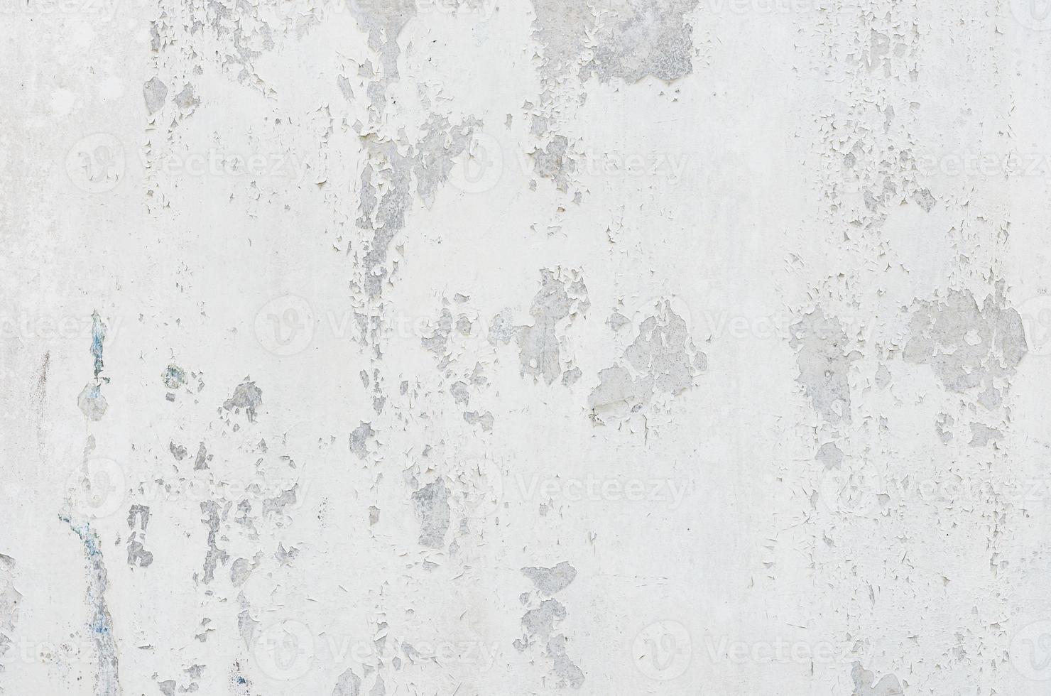 white white background and texture of peeling paint on plaster wall because  old paint expired. photo