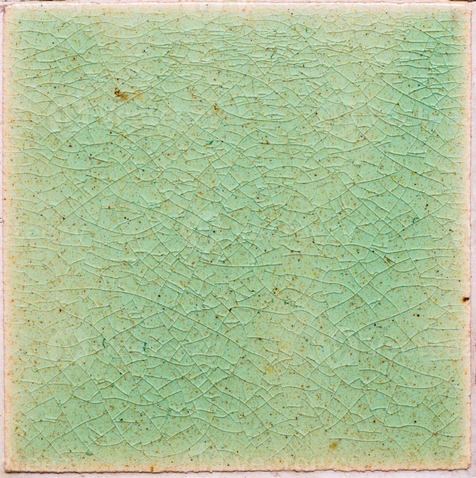 background and texture of stretch marks cracked on emerald green glazed tile photo